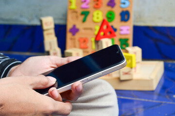 Close up playing smartphone and puzzle