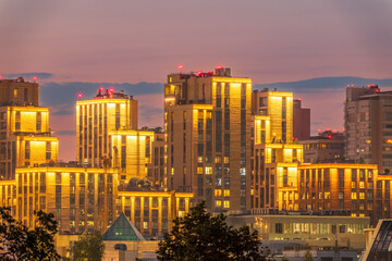 Night colorful windows lights of the high-rise residential building in city sleeping area