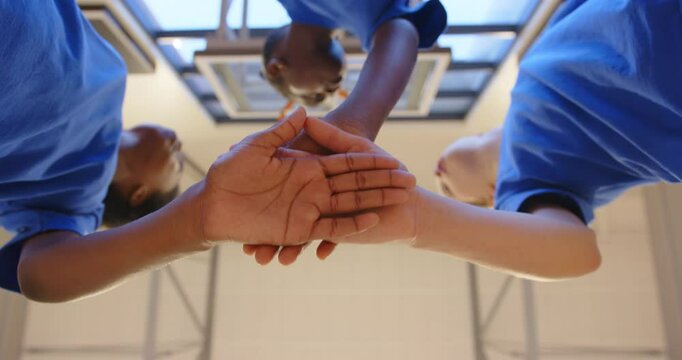 Students in school gym huddling together, showing teamwork and unity