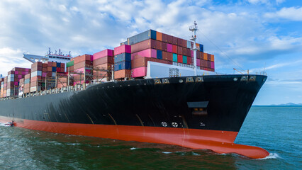 Aerial side view of cargo ship carrying container and running for export cargo yard port to custom...