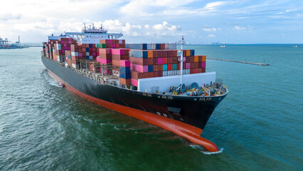 Fototapeta premium Aerial side view of cargo ship carrying container and running for export cargo yard port to custom ocean concept technology transportation , customs clearance, webinar banner forwarder mast