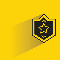 star shield badge icon with shadow on yellow background
