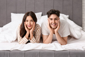 Young couple lying together in bed
