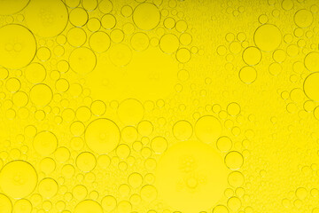 Macro microscope yellow bubble texture, Close-up Yellow bubbles and drops oil background . golden Yellow water bubbles, close up golden oil drop for celebration