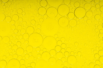Macro microscope yellow bubble texture, Close-up Yellow bubbles and drops oil background . golden Yellow water bubbles, close up golden oil drop for celebration