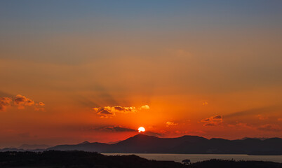 At dusk, the sun sets over the island.
