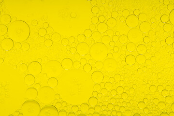 Macro microscope yellow bubble texture, Close-up Yellow bubbles and drops oil background . golden Yellow water bubbles, close up golden oil drop for celebration
