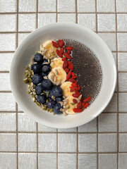 healthy nutritional bowl of food made with chia pudding fresh fruit and nuts