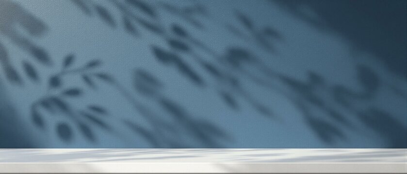 Empty table on dark blue texture wall background. Composition with organic shadow on the wall and light reflections. Mock up for presentation, branding products, cosmetics food or jewelry.