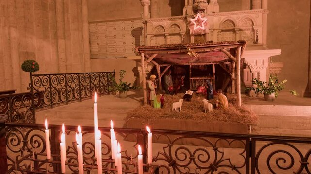 A serene nativity scene with candles in Church Saint-Nicolas, Blois, France