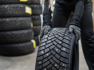 Mechanic keeps new studded car tires in garage. 