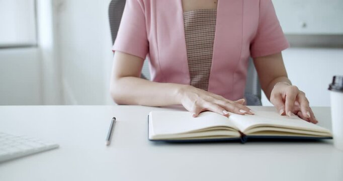 A focused individual enjoys a coffee break while jotting notes in a notebook emphasizing productivity and work-life balance.