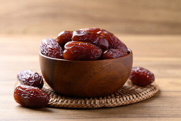 Date palm fruit (MedJool) in wooden bowl