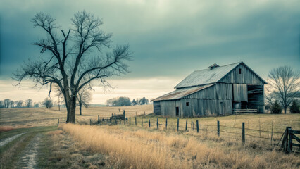 Fototapeta premium rustic barn stands beside large tree in serene landscape