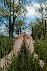 Feet on the grass, promoting grounding and mental stability