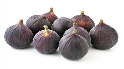 Fototapeta premium Fresh figs arranged in a geometric pattern on a clean white background showcasing their rich color and natural texture