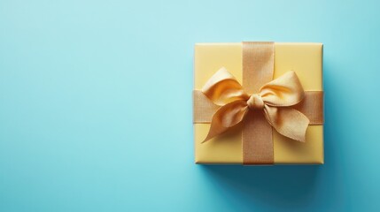 Yellow gift box with ribbon on blue backdrop empty space for text vibrant celebration concept ideal for festive promotions and announcements