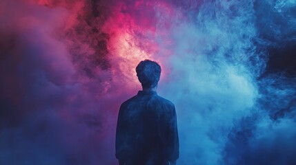 Fototapeta premium Mysterious Silhouette of Man Surrounded by Vibrant Colorful Smoke at Night Creating an Ethereal Atmosphere