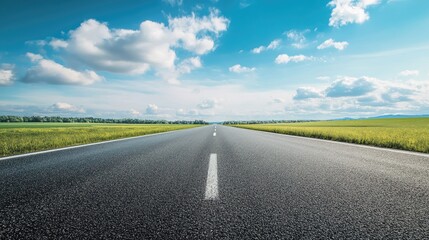 Blank highway landscape for automotive design projects featuring green fields under a blue sky with clouds suitable for creative copyspace use.