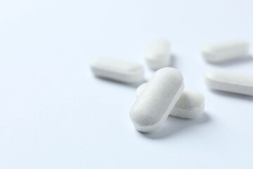 White pills on white background