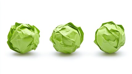 Crumpled green paper balls on a white background showcasing texture and color variations for creative design and artistic concepts