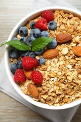 Delicious granola with berries on a wooden background