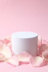 Pink rose petals with podium on a color background