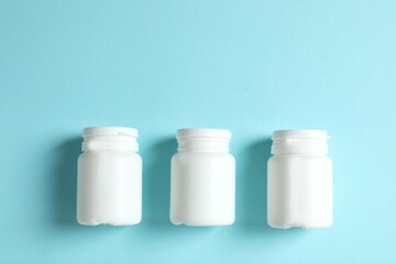 White bottles on color background 