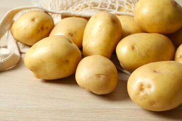 Young potatoes. Fresh potatoes on a wooden background. Harvesting collection. organic, freshly dug potatoes. Agricultural background. Vegan. Vegetables.Place for text.Copy space