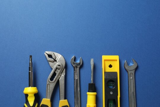 Set of tools on color background, top view