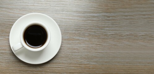 Cup with coffee on wooden background 