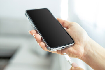 Hand charging phone with usb cable at home