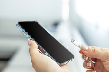 Hand charging phone with usb cable at home