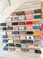 Leather and fabric bags of different colors exhibited in the modern shopping mall or market