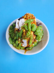 Cendol is a Malaysian dessert made of shaved ice, coconut milk, green pandan jelly noodles, and sweet dark brown sugar syrup. 