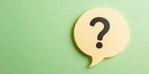 A speech bubble with a question mark in bold on a pastel green background, symbolizing curiosity, communication, and inquiry.