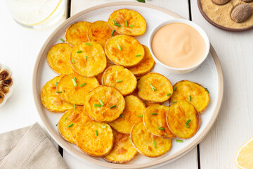 Baked potatoes with sauce. Homemade chips. Appetizer. Snack. Vegetarian food.