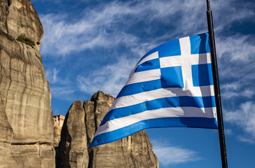 Flag of Greece waving above Greek orthodox monasteries in Meteora.