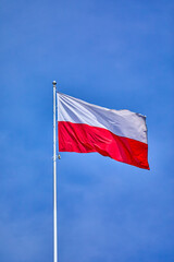 National Flag of Poland with clear blue sky in background, Warsaw, Poland, Europe