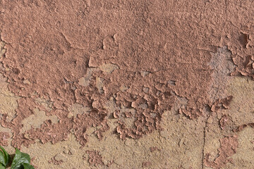 Earthy orange brown and yellow toned grunge wall background texture for textured stone backdrop for ad space or copy space