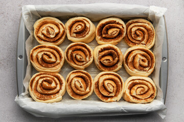 Delicious cinnamon rolls prepared for baking in a rectangular pan