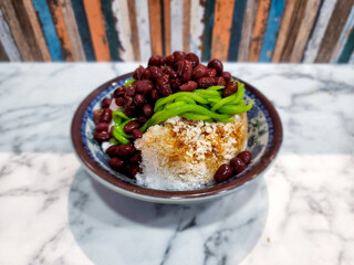 Cendol is a Malaysian dessert made of shaved ice, coconut milk, green pandan jelly noodles, and sweet dark brown sugar syrup. 
