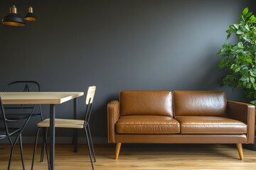 Contemporary living room featuring a stylish brown leather sofa, wooden dining table, and lush green plant against a dark wall.