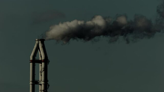 Chimneys of an industrial factory emitting thick pollution smoke, Concept of environmental impact, Economy or business