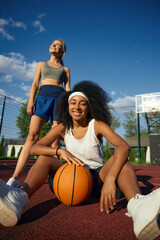 Two attractive multicultural female basketball player taking rest