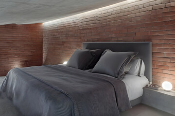 Modern Bedroom Design Showcases Brick Wall, Cozy Bed, and Ambient Lighting