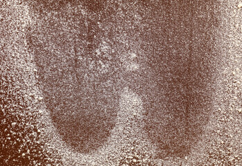 A close up of a brown surface with white specks on it