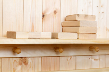 A wooden shelf with a bunch of wooden blocks on it