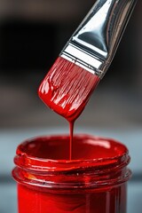 Close-up of a paintbrush in red paint. Selective focus