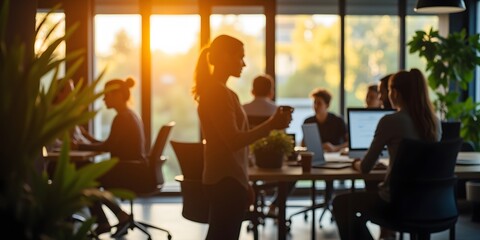Golden Hour Office: Silhouetted figures work amidst the warm glow of a setting sun, creating a serene and productive atmosphere.  The scene captures a moment of calm focus.